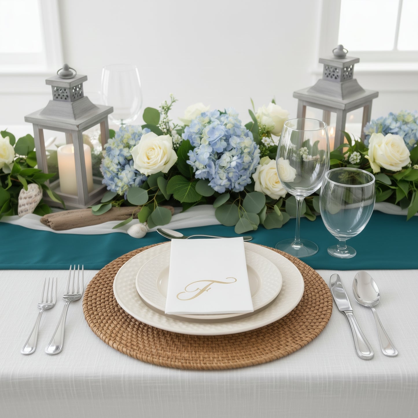 White napkin with gold foil monogram "F" on a decorative table setting.