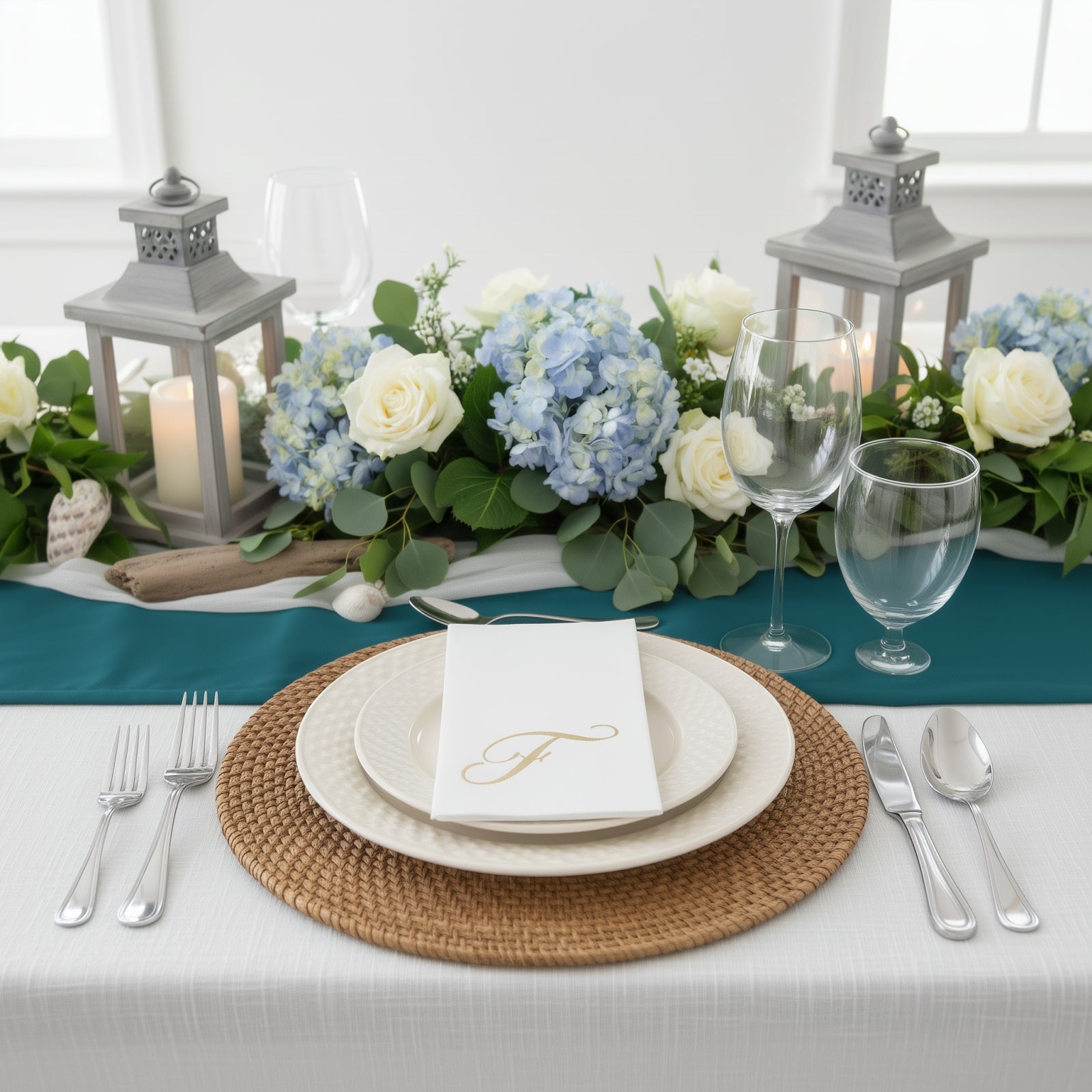 White napkin with gold foil monogram "F" on a decorative table setting.