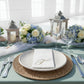 White napkin with gold foil monogram "T" on a beautifully set table.