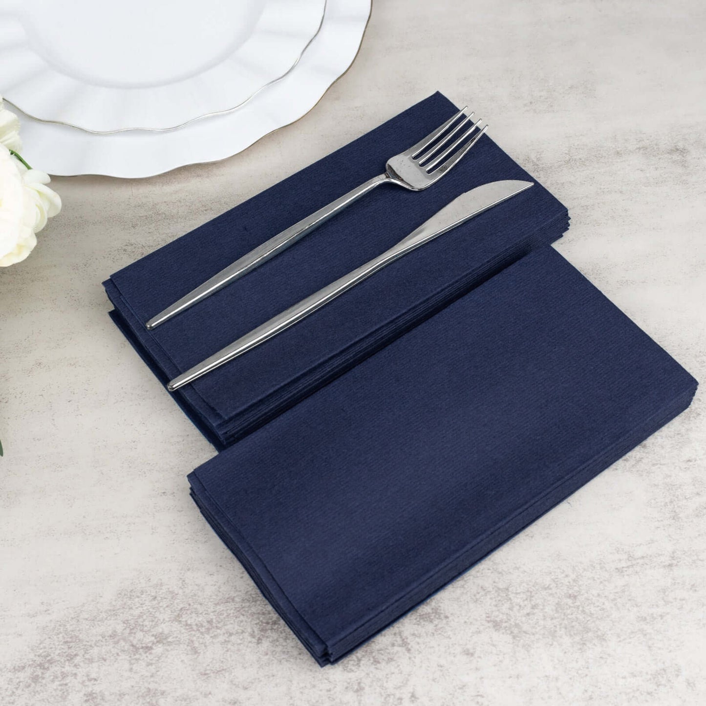 Navy blue linen-feel disposable dinner napkins with silver cutlery.