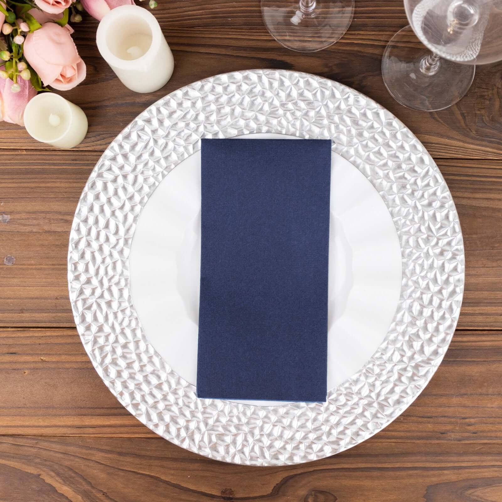Navy blue linen-feel paper napkin on an elegant dining plate setting.