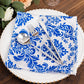 Royal blue and white damask flocking taffeta napkin on a plate.