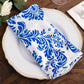 Royal blue and white damask flocking taffeta napkin on a plate.