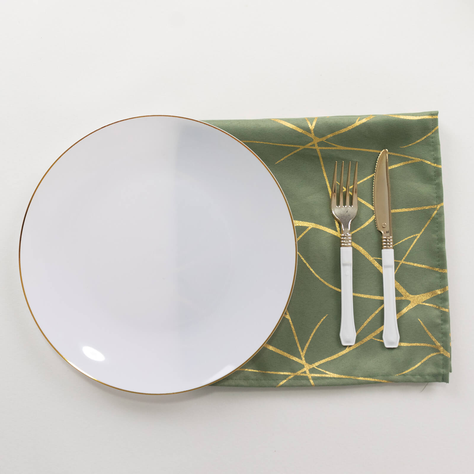 Dusty sage green dinner napkin with gold foil tree branch pattern.