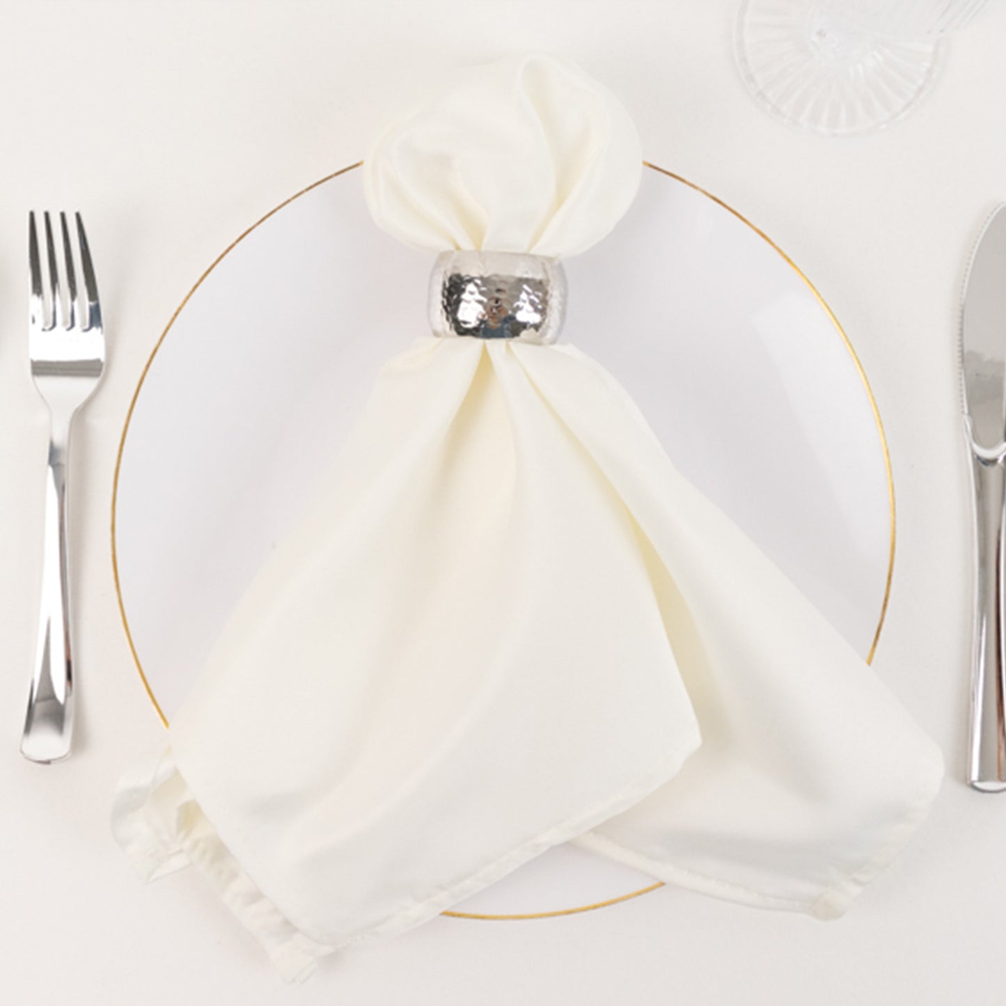 Ivory satin dinner napkins with soft matte finish on a plate.