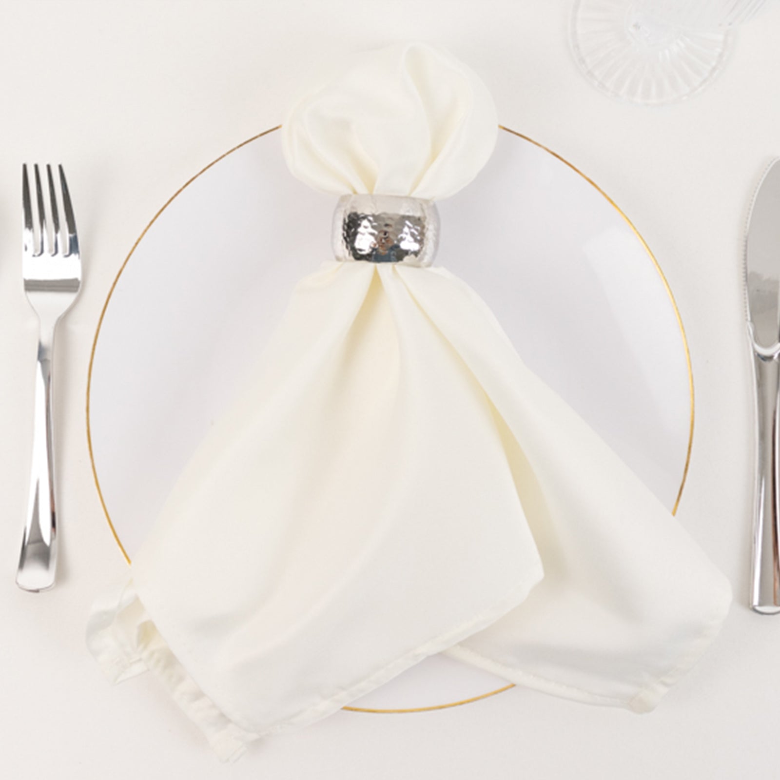 Ivory satin dinner napkins with soft matte finish on a plate.