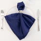 Navy blue satin napkin elegantly displayed on a dinner plate.