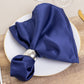 Navy blue satin napkin elegantly arranged on a dinner plate.