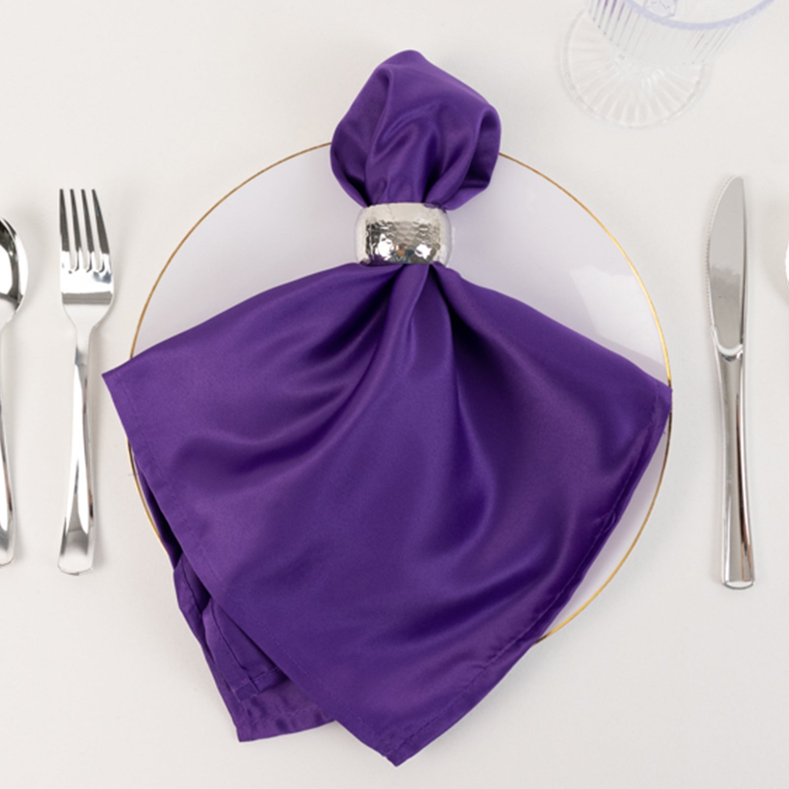 Purple satin napkin elegantly styled on a plate.