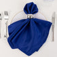 Royal Blue Lamour Satin Napkin on a plate with silver napkin ring.