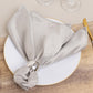 Silver satin napkin elegantly styled on a plate.