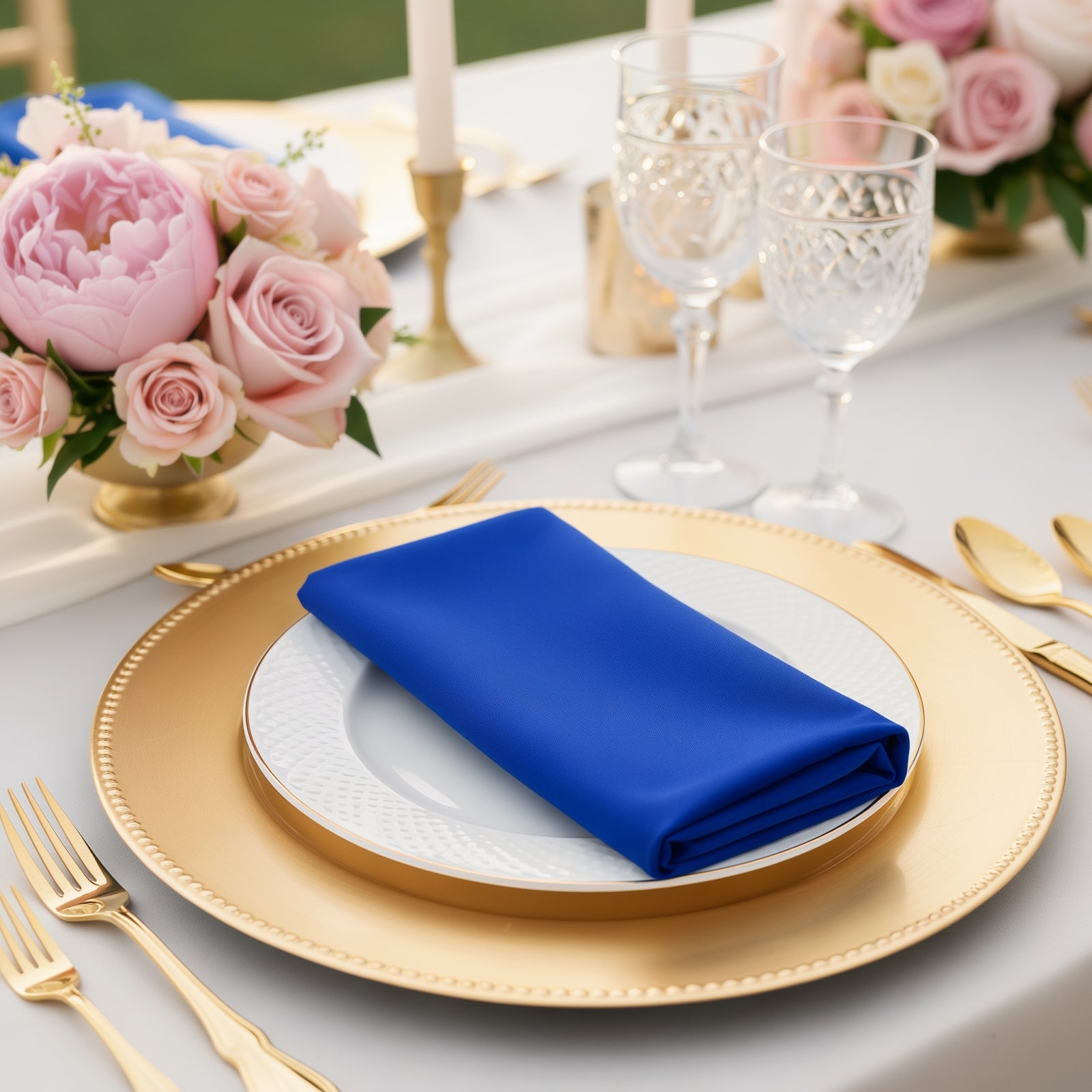 Royal blue scuba napkin on an elegant table setting with floral decor.