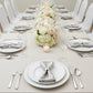 Shimmer silver cloth napkins on an elegantly set dining table.