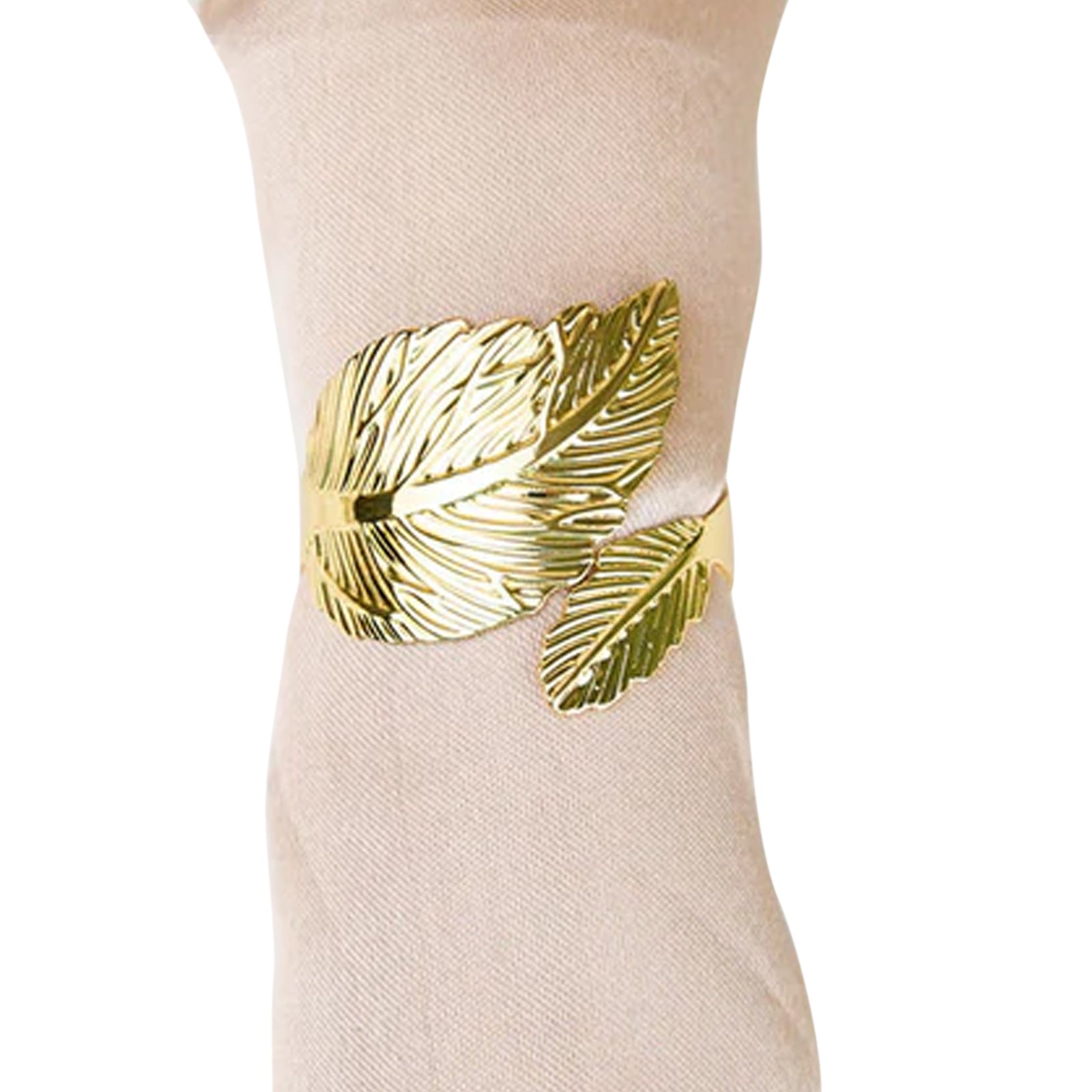 Metallic gold ornate leaf napkin rings on a linen napkin.