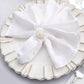Elegant silver floral napkin ring on a white napkin.