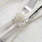 Elegant silver metal floral napkin ring with daisy flower design.