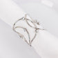 Silver metal napkin rings with rhinestones in a woven design.