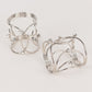 Silver metal napkin rings with rhinestones, elegant woven design.