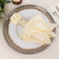 Silver metal napkin rings with rhinestones on a white plate with yellow napkins.