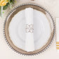 Silver metal napkin ring with rhinestones on a white napkin. Elegant table setting.