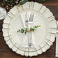 Rustic green eucalyptus leaf wooden beaded jute napkin rings on elegant table setting.