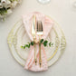 Rustic green eucalyptus leaf wooden beaded jute napkin rings on a pink napkin.