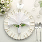 Rustic green eucalyptus leaf wooden beaded jute napkin rings on a white plate.