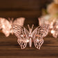 Rose gold butterfly napkin rings for elegant table settings.