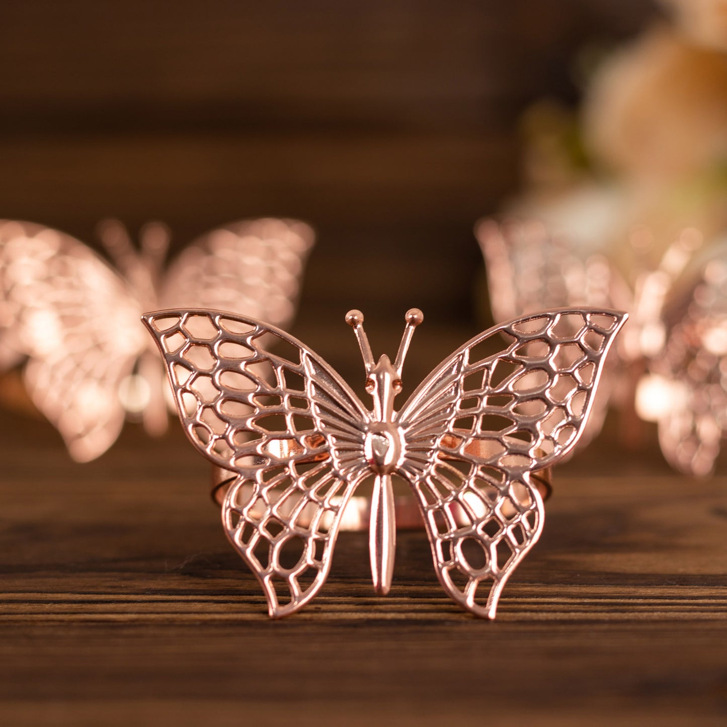 Rose gold butterfly napkin rings for elegant table settings.