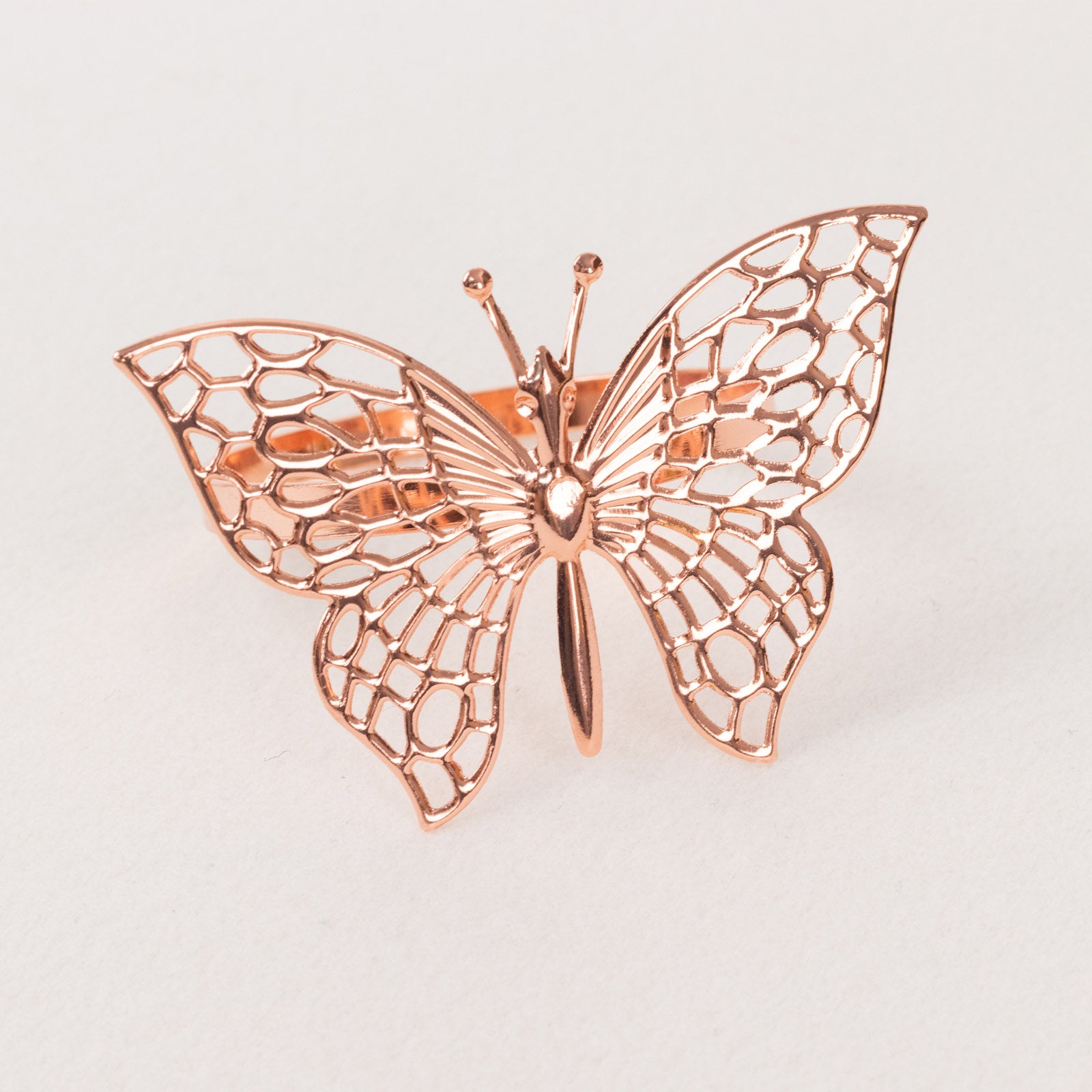 Rose gold butterfly napkin ring holder, decorative laser cut design.