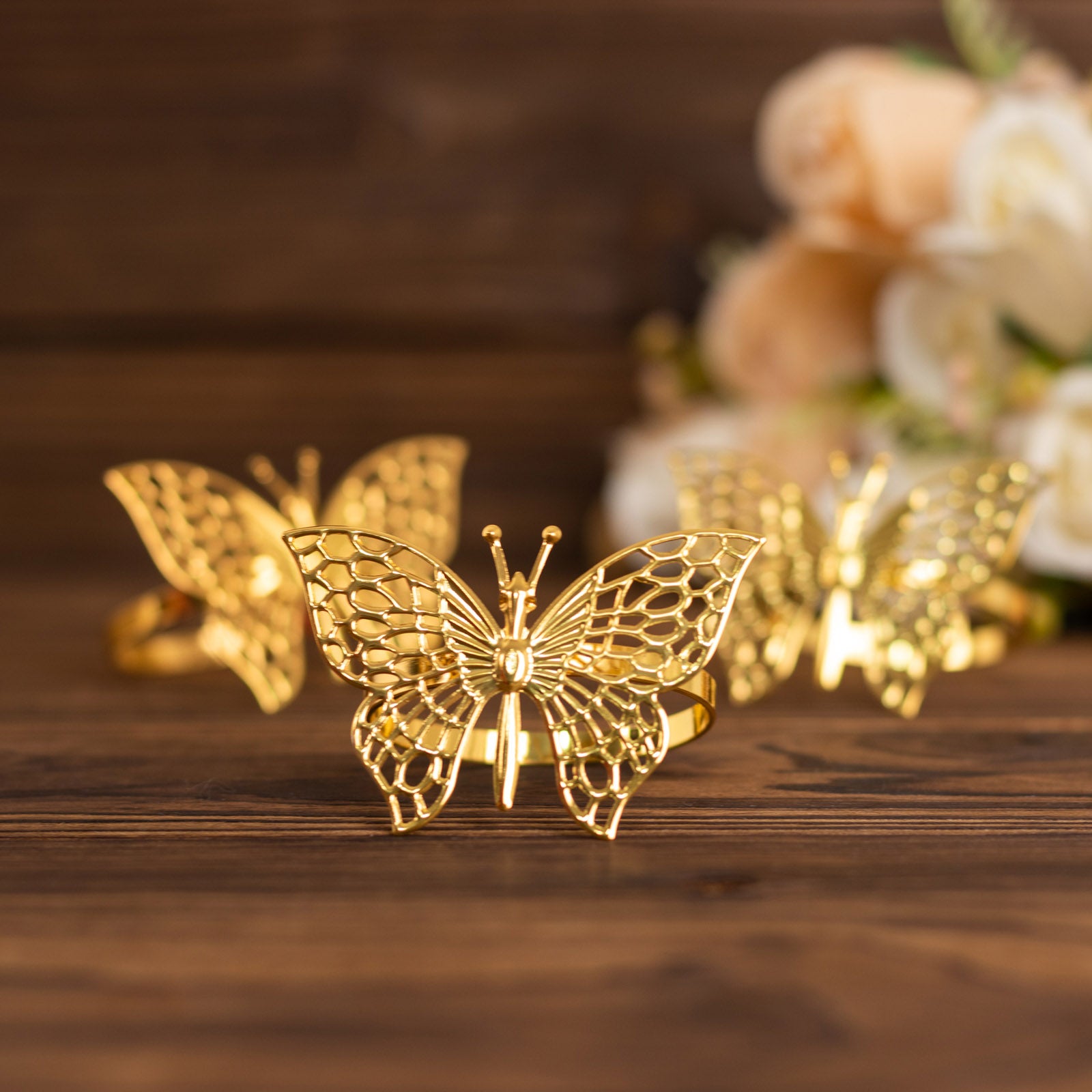 Gold metal butterfly napkin rings for decorative table settings.