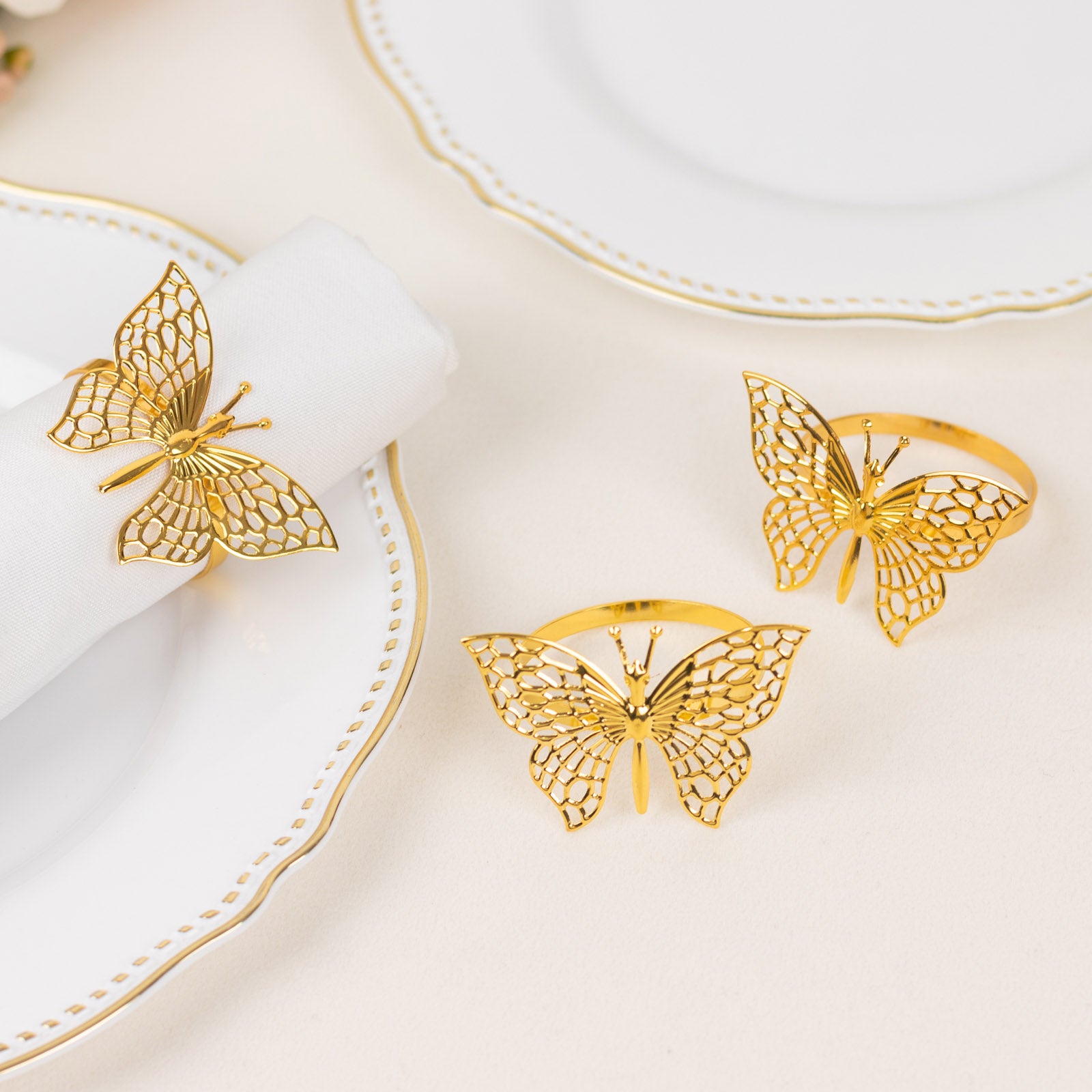 Gold butterfly napkin rings for elegant table settings.