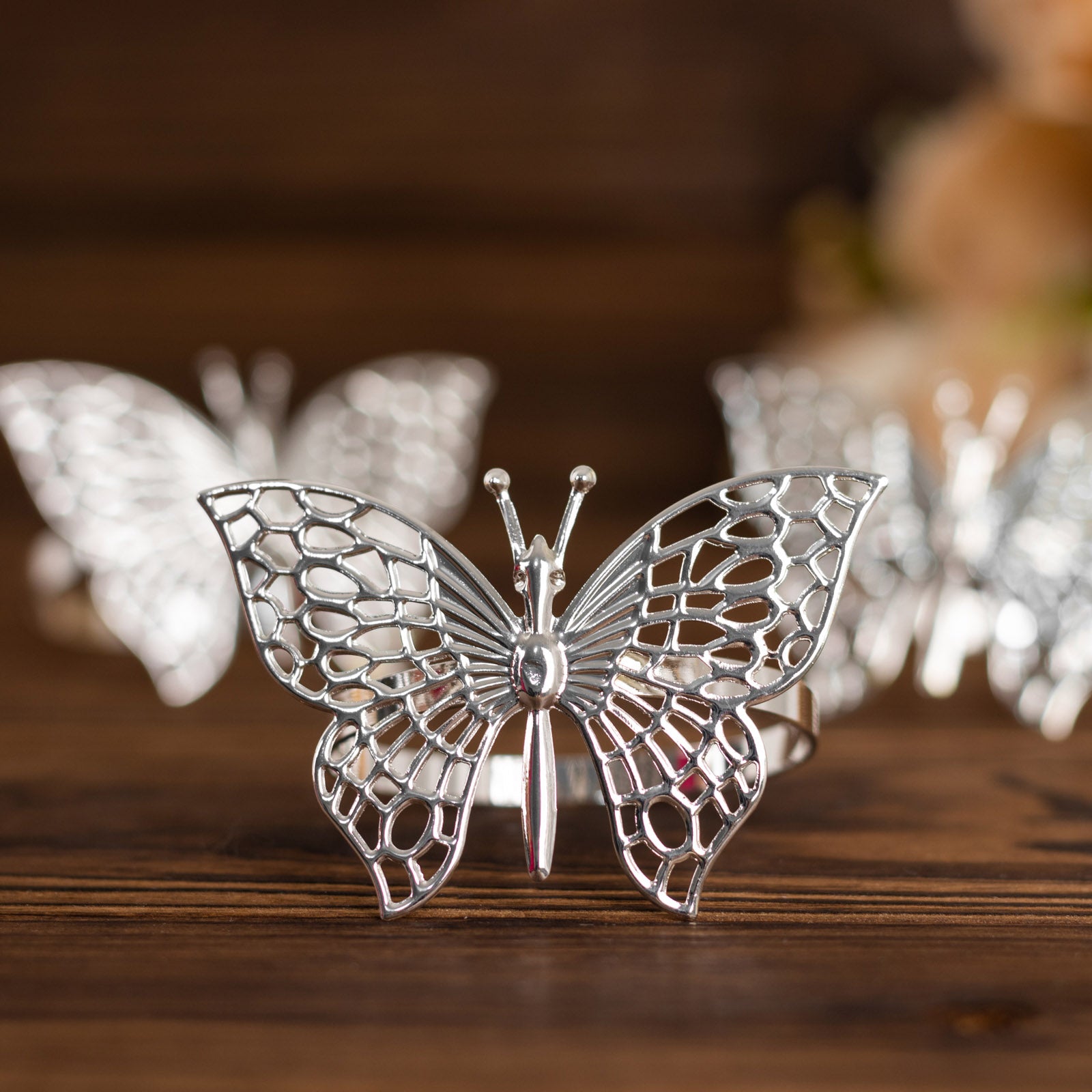 Silver metal butterfly napkin rings for decorative table settings.
