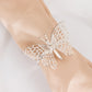 Silver butterfly napkin ring holder on a beige napkin.