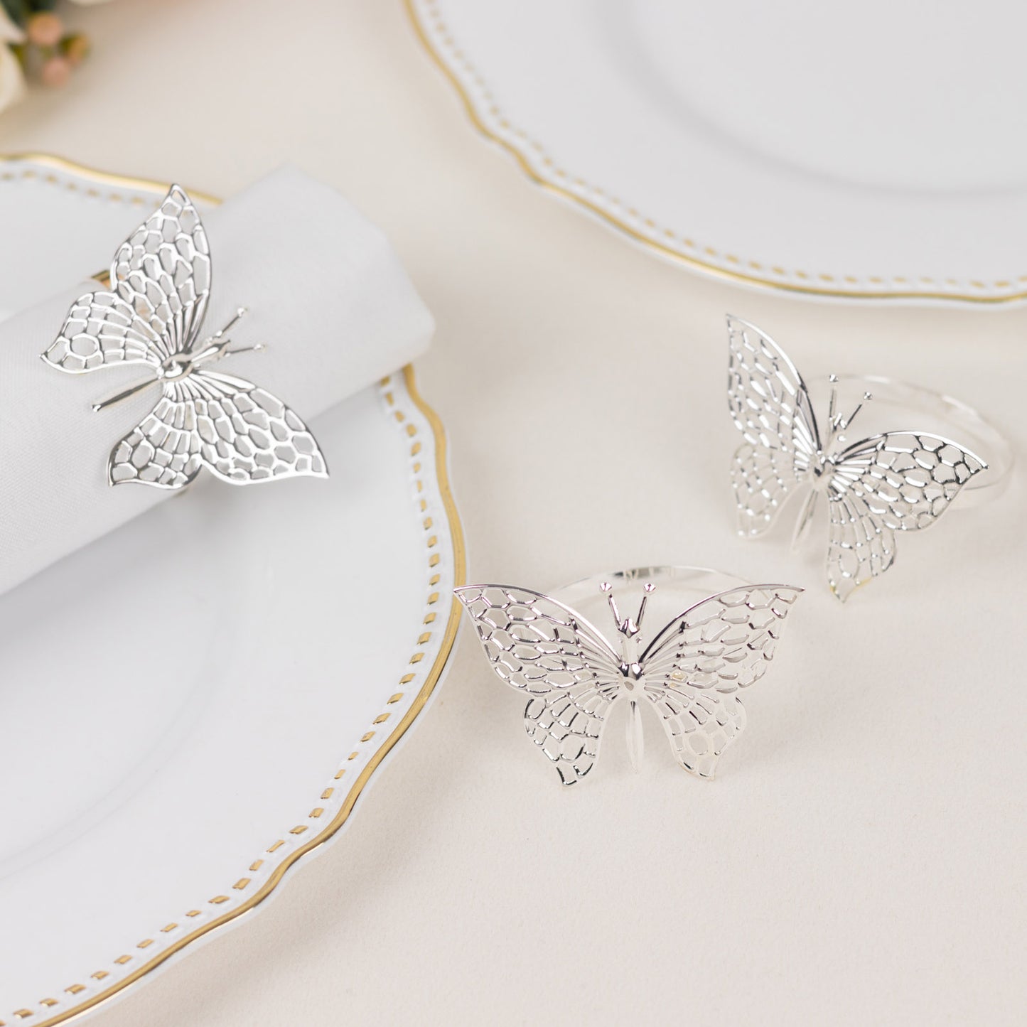 Silver butterfly napkin rings, decorative laser cut holders for elegant table settings.