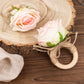 Blush artificial rose wooden napkin holder with farmhouse rustic design.