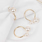 White pearl and gold metal napkin holders for elegant dining decor.