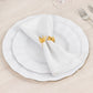 Gold laser cut butterfly napkin holder on white dinner plate.