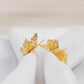 Gold butterfly metal napkin holder, elegant dining table decor.