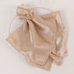 Amber gold floral napkin holder with rhinestone accents on a napkin.