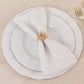 Amber gold floral metal napkin holder with rhinestone accents on a white napkin.