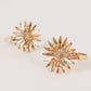 Amber gold floral napkin holders with rhinestone accents, decorative metal rings.