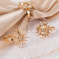 Amber gold floral metal napkin holders with rhinestone accents.