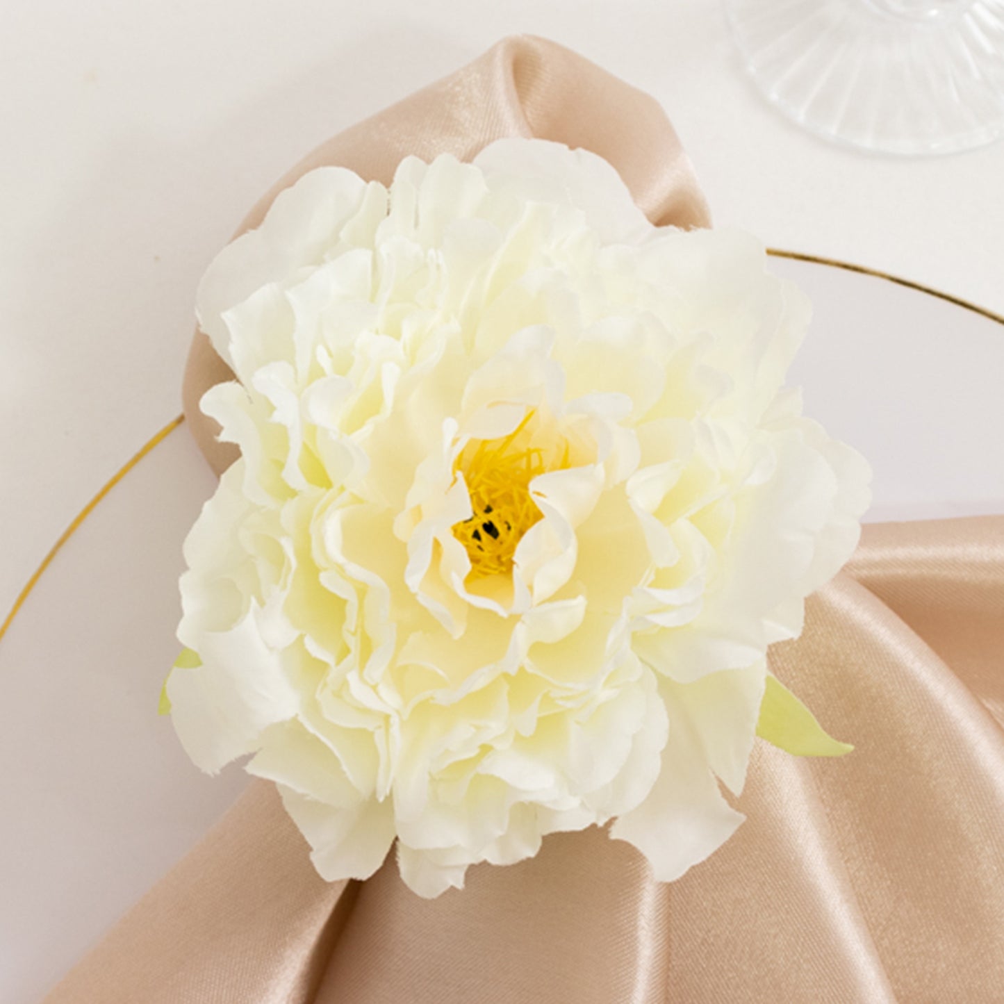 Ivory floral napkin holder with silk peony for elegant dining table settings.