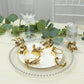 Glossy gold metal leaf napkin rings on a decorative plate.