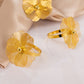 Gold metal jasmine flower napkin holders with pearl center.