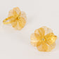 Gold metal floral napkin holders with pearl center, decorative and elegant design.