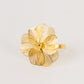 Gold metal flower napkin holder with pearl center, decorative floral design.