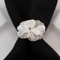 Silver metal jasmine flower napkin holder with pearl center.