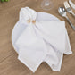 Gold butterfly napkin holders with crystal accents on a white napkin.